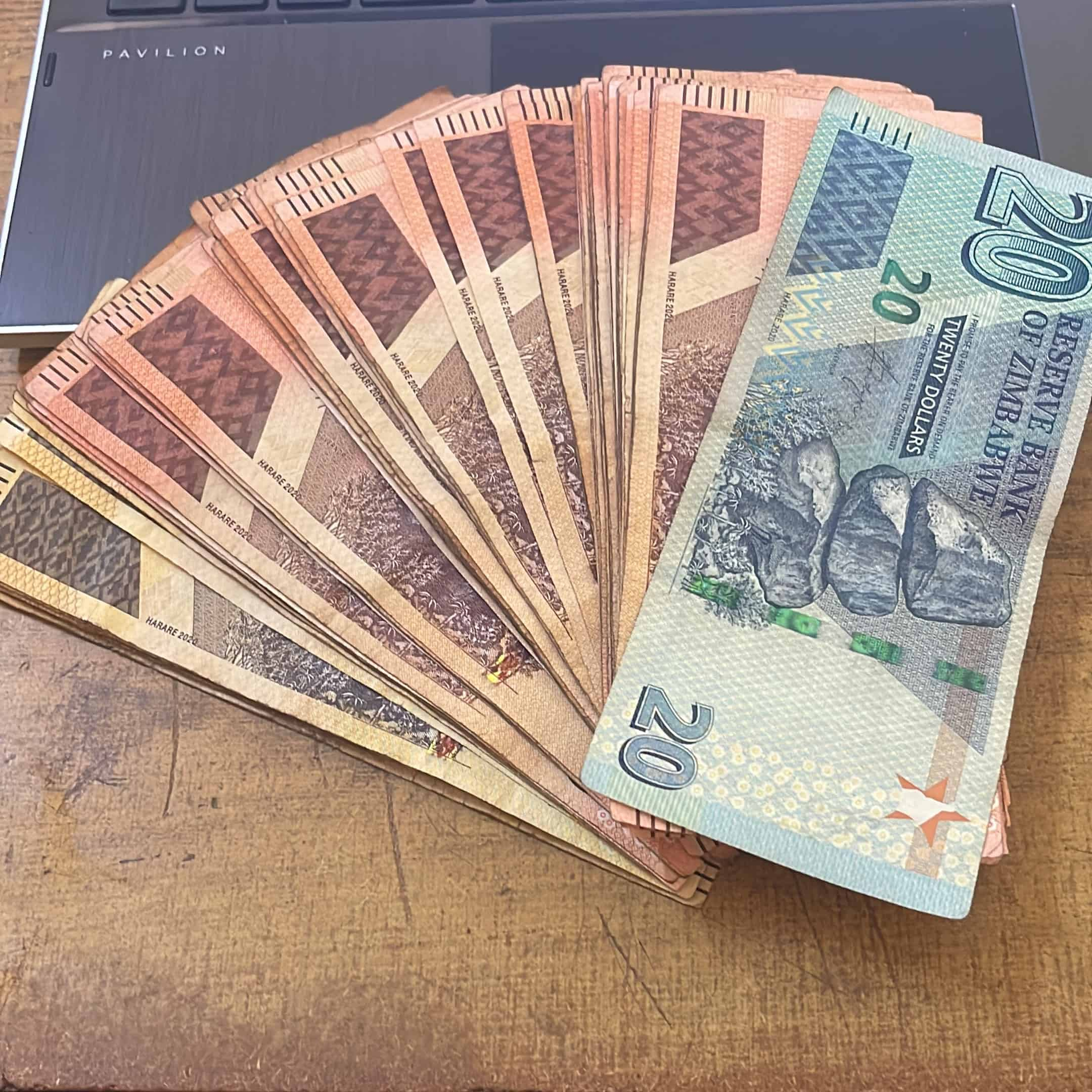 A bunch of Zimbabwean bank notes spread across the table