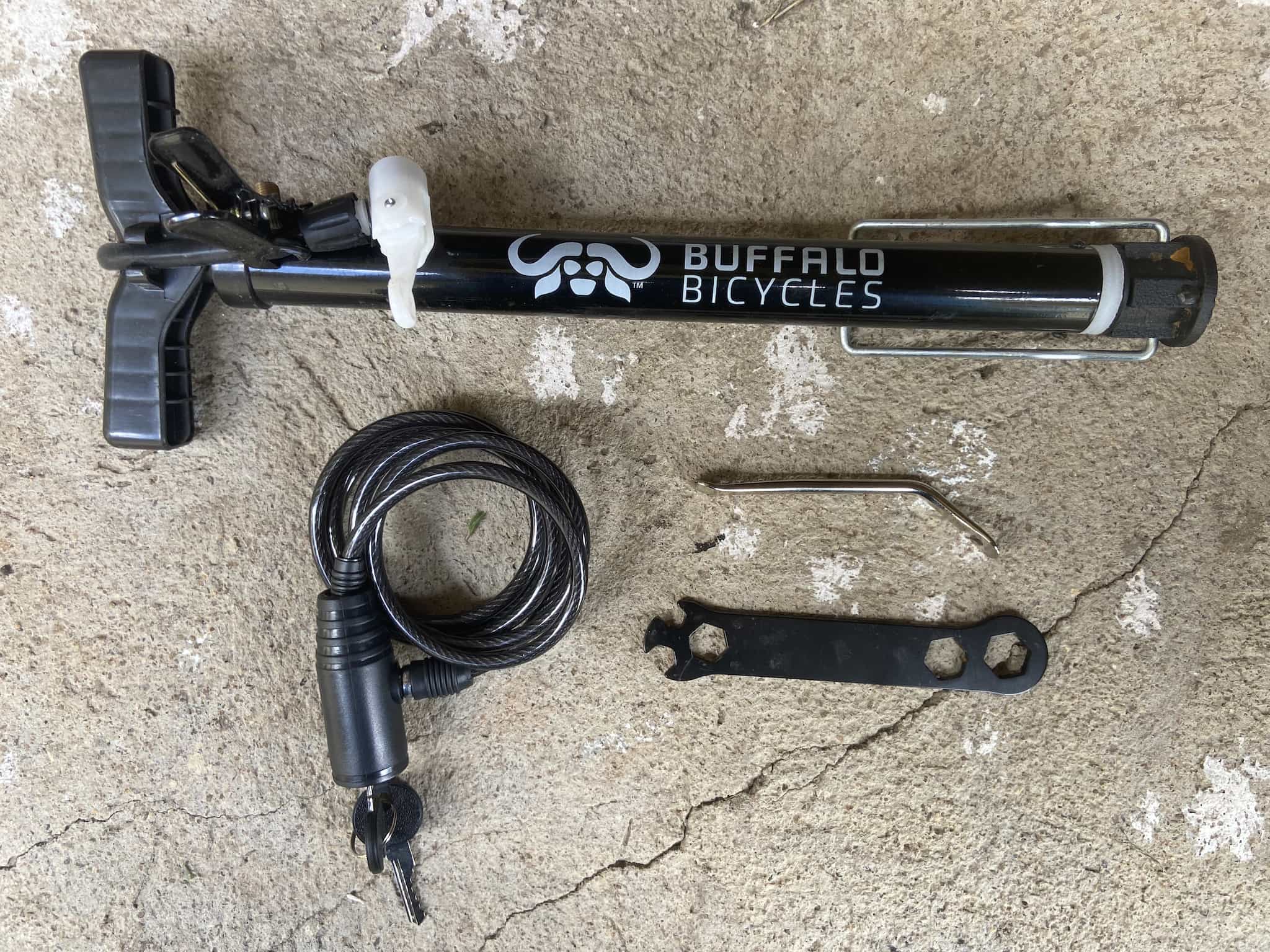 A bike pump, lock and two tools