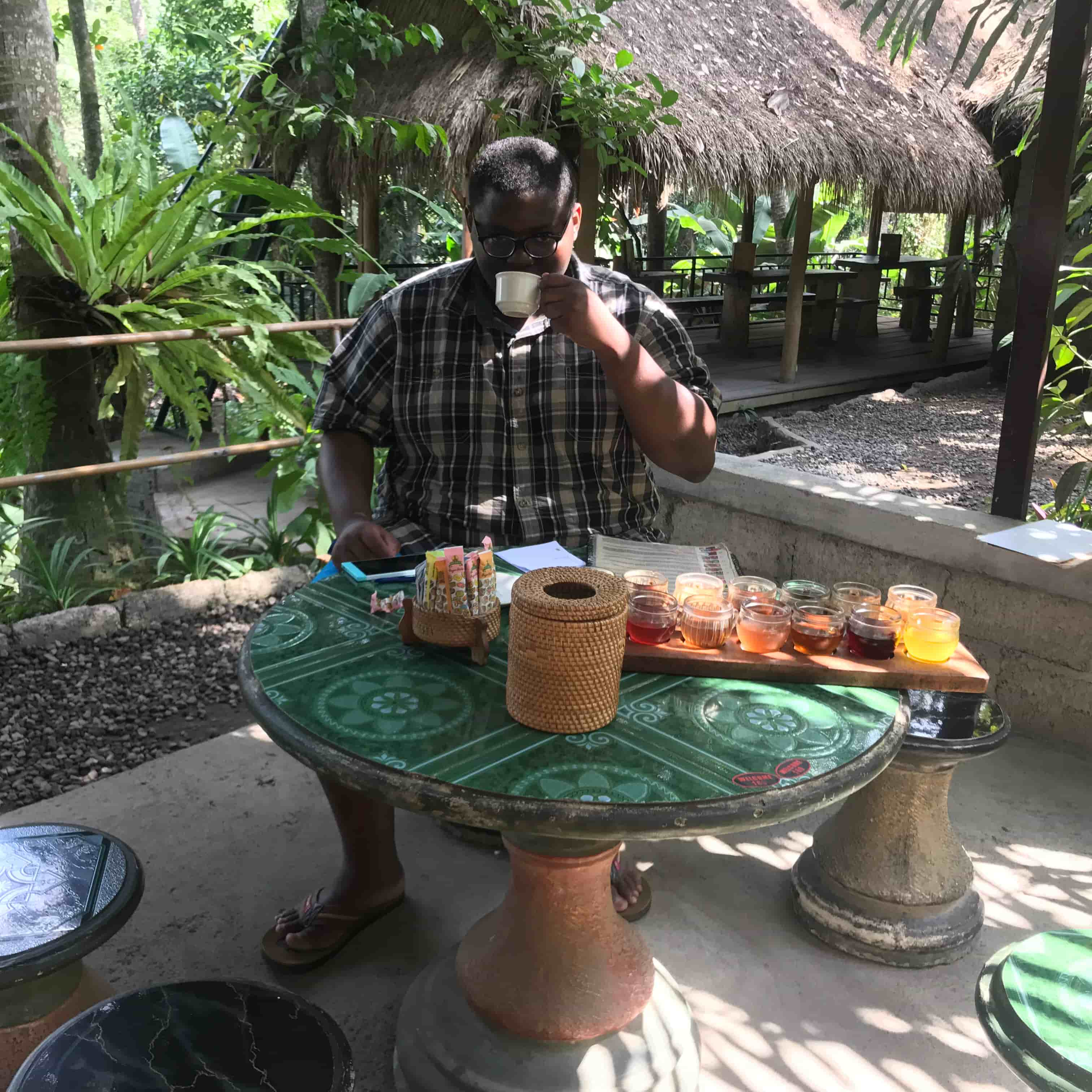 My fatass sitting incredibly seriously on a table with lots of beverages to try as if I’m a professional